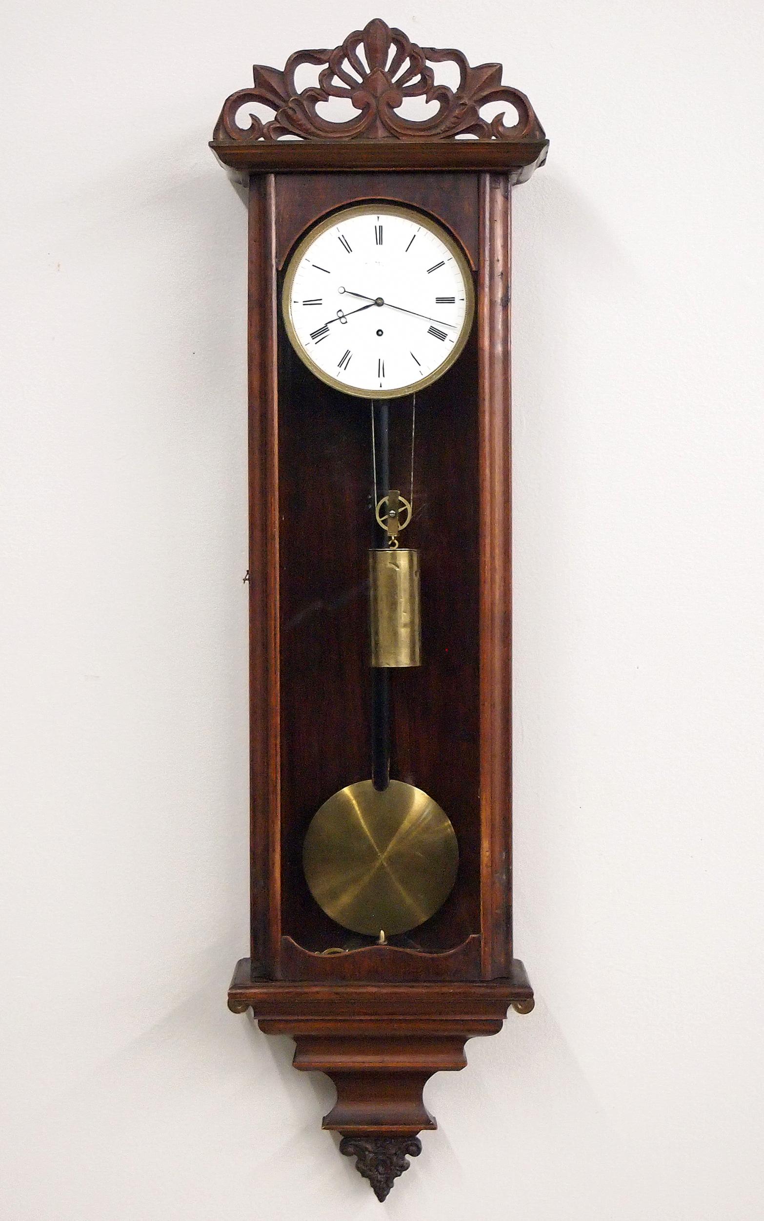 Dwarf 1 Weight Vienna Regulator: A 19th century Dwarf Vienna Regulator wall clock. 8-day weight driven time only movement with a 5" flat porcelain dial, Roman numerals and engine turned bezel. Rosewood case with a carved crest and mo