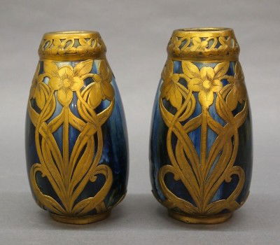 Pr Langlade vases: A pair of late 19th century French Art Nouveau period vases by Jean Langlade (1879-1928). Metallic glazed earthenware bodies with engraved Bras floral overlays. One with impressed mark the second with