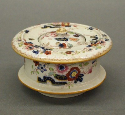 Mason's Ironstone inkwell: A 19th century Mason's Ironstone inkwell, with "Eastern Garden" decoration. Molded body and cover, decorated with a transfer scene and polychrome enamel detail. Red printed mark. Slight crazing, some 
