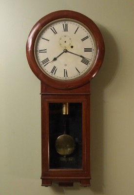 Seth Thomas #2 Regulator: A 19th century Seth Thomas #2 regulator wall clock. 8-day weight driven time only movement with seconds bit. Mahogany case with veneered upper door, Black paper label in case 80% intact. Old finish wi