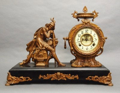 New Haven figural mantle clock: A turn of the century New Haven "Ivanhoe" model figural mantle clock. 8-day time and strike movement with porcelain dial and open escapement. Cast Spelter patinated case and figure on an Iron base. So