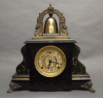 Gilbert Bell top mantle clock: A late 19th century Gilbert "Curfew" model mantle clock. 8-day time and strike movement with pierced Brass dial, and Bell strike on top of the case. Ebonized wooden case with Marbleized decoration and