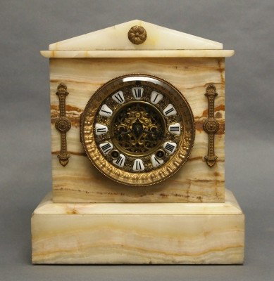 Ansonia Onyx mantle clock: A turn of the century Ansonia White Onyx mantle clock. 8-day time and strike movement with open escapement and fancy pierced dial. Minor wear, lacks rear door. 11" high. ESTIMATE $100-150