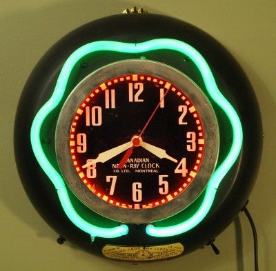 Neon gallery clock: A mid 20th century Neon gallery clock by the "Canadian Neon Ray Clock Co., Montreal". Painted metal case. Minor wear, clock not functioning. 13" diameter. ESTIMATE $100-200