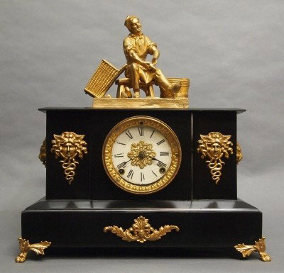 Ansonia mantle clock: A turn of the century Ansonia "Bath" model Iron mantle clock with patinated Spelter figure. 8-day time and strike movement. Some wear, touchups. 17" high overall. ESTIMATE $100-200