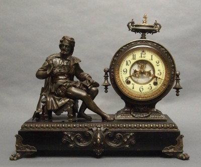 Ansonia figural mantle clock: A turn of the century Ansonia "Arion" model figural mantle clock. 8-day time and strike movement with porcelain dial and open escapement. Cast Spelter patinated case and figure on an Iron base. Some w