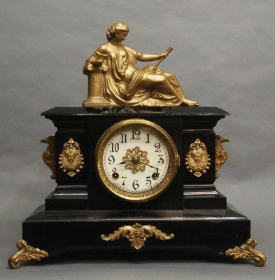 Ansonia mantle clock: A turn of the century Ansonia "Butte" model Iron mantle clock with patinated Spelter figure. 8-day time and strike movement. Minor wear, restored dial. 17" high overall. ESTIMATE $100-150