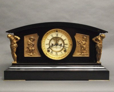 Ansonia mantle clock: A turn of the century Ansonia "Monterey" model Iron mantle clock.. 8-day time and strike movement. Minor wear, dial chips, restored finish on mounts, lacks rear cover. 9 1/2" high overall. ESTIMATE $1