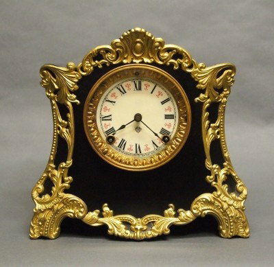 Ansonia mantle clock: A turn of the century Ansonia "Hague" model Iron mantle clock. 8-day time and strike movement. Minor wear, gold repainted. 10 1/4" high. ESTIMATE $100-150