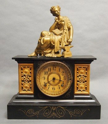 Ansonia mantle clock: A turn of the century Ansonia Iron mantle clock with painted Spelter figure. 8-day time and strike movement. Some wear, touchups, hinge repair. 18" high overall. ESTIMATE $100-200