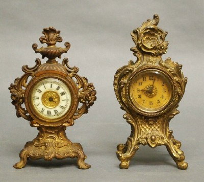2 Ansonia Novelty clocks: Two early 20th century Ansonia Novelty clocks. Fancy Spelter cases case with foliate detail, 30 hr time only movements. Some wear, one lacks hands. Up to 7 1/2" high. ESTIMATE $50-75