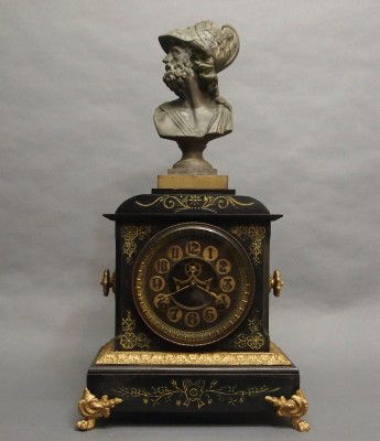 Ansonia mantle clock: A turn of the century Ansonia "St Clair" model Iron mantle clock with patinated Spelter figure. 8-day time and strike movement with open escapement. Repainted with some wear, handle loss. 20" high ove