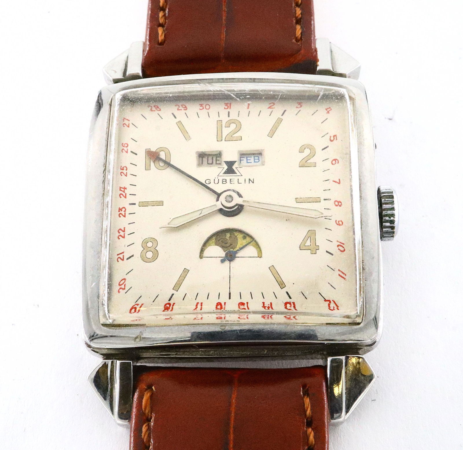 Gubelin Wristwatch: A vintage Gubelin Triple Calendar gentleman's wristwatch. Manual wind with Slivered dial, Arabic numerals with subsidiary seconds, day, month and moon phase apertures. 31 mm Stainless case with replac