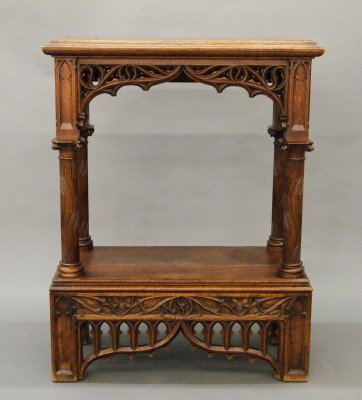 Gothic console table: A late 19th century Gothic Revival Oak console table. Molded top above shaped skirts with pierced carved skirt, pierced carved back. Old finish with wear and minor damage. 34 x 17 x 44" high. ESTIMATE