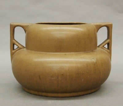 Fulper urn: A 20th century Fulper Art Pottery urn. Squat form with buttress handles in a Matte Brown glaze. Stamped vertical "Fulper" mark. Minor surface wear. 6 1/2" high. ESTIMATE $300-400