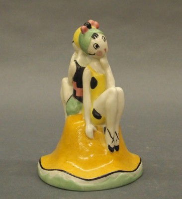 Fulper lamp: A 20th century Fulper "Fish" figural lamp. Two bathers sitting on a sand castle. Stamped vertical mark, and stamped "Fish". Slight wear, lacks electrical fittings. 6" high. ESTIMATE $100-200