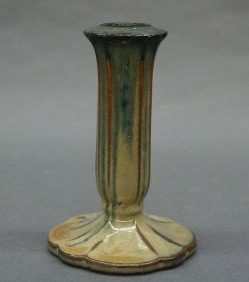 Fulper Pottery candlestick: A 20th century Fulper Art Pottery candlestick. Fluted stem on a petal base with a Blue/Tan Flambe glaze. Impressed horizontal "Fulper" mark with "825". Minor surface wear. 4 1/2" high. ESTIMATE $50-75