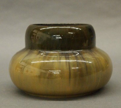 Fulper Pottery vase: A 20th century Fulper Art Pottery bowl. Simple shouldered design with a Brown/Tan Cat's-eye glaze. Stamped vertical "Fulper" mark. Minor surface wear. 6" diameter. ESTIMATE $50-75
