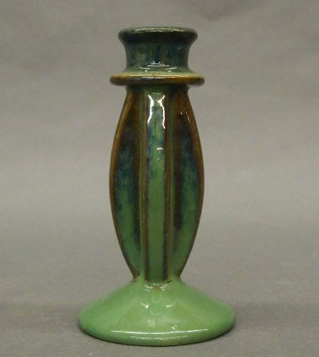 Fulper Pottery candlestick: A 20th century Fulper Art Pottery candlestick. Curved pillar stem on a domed foot in a Blue/Green glaze. Impressed horizontal "Fulper" mark. Slight surface wear. 6" high. ESTIMATE $50-75