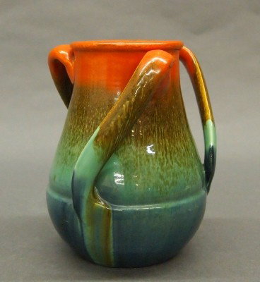 Stangl vase: A 20th century Stangl Art Pottery vase. Bulbous body with three slanted handles in a Sunburst glaze. Unmarked. Slight surface wear. 7" high. ESTIMATE $100-150