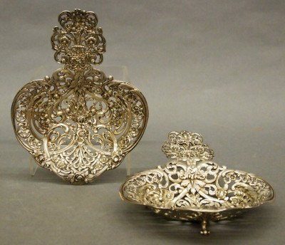 Pair of Tiffany Bonbonieres: A pair of turn of the century Tiffany & Co. Sterling Silver Bonbonieres. Rococo style bodies with reticulated scrollwork and foliate design detailed with fruit filled cornucopia handles and fine flora
