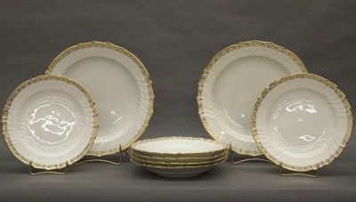 8 KPM Porcelain bowls: Eight late 19th century KPM porcelain bowls. Molded bodies with scalloped edges and gilded rims. Printed and impressed marks. Six at 9 1/2" diameter and 2 at 12 1/2" diameter. Some wear, 3 smaller bow