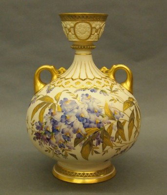 Royal Worcester vase: A late 19th century Royal Worcester porcelain vase. Molded bulbous form with medallion rim detail and two scrolled handles. Hand painted floral design with extensive Gilded detail. Printed and impress