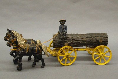 Hubley Log wagon: A turn of the century Hubley Cast Iron toy horse drawn logging wagon. Features a removable driver, two horses and a 4 wheel wagon hauling a large log. Original painted finish with wear and some paint 