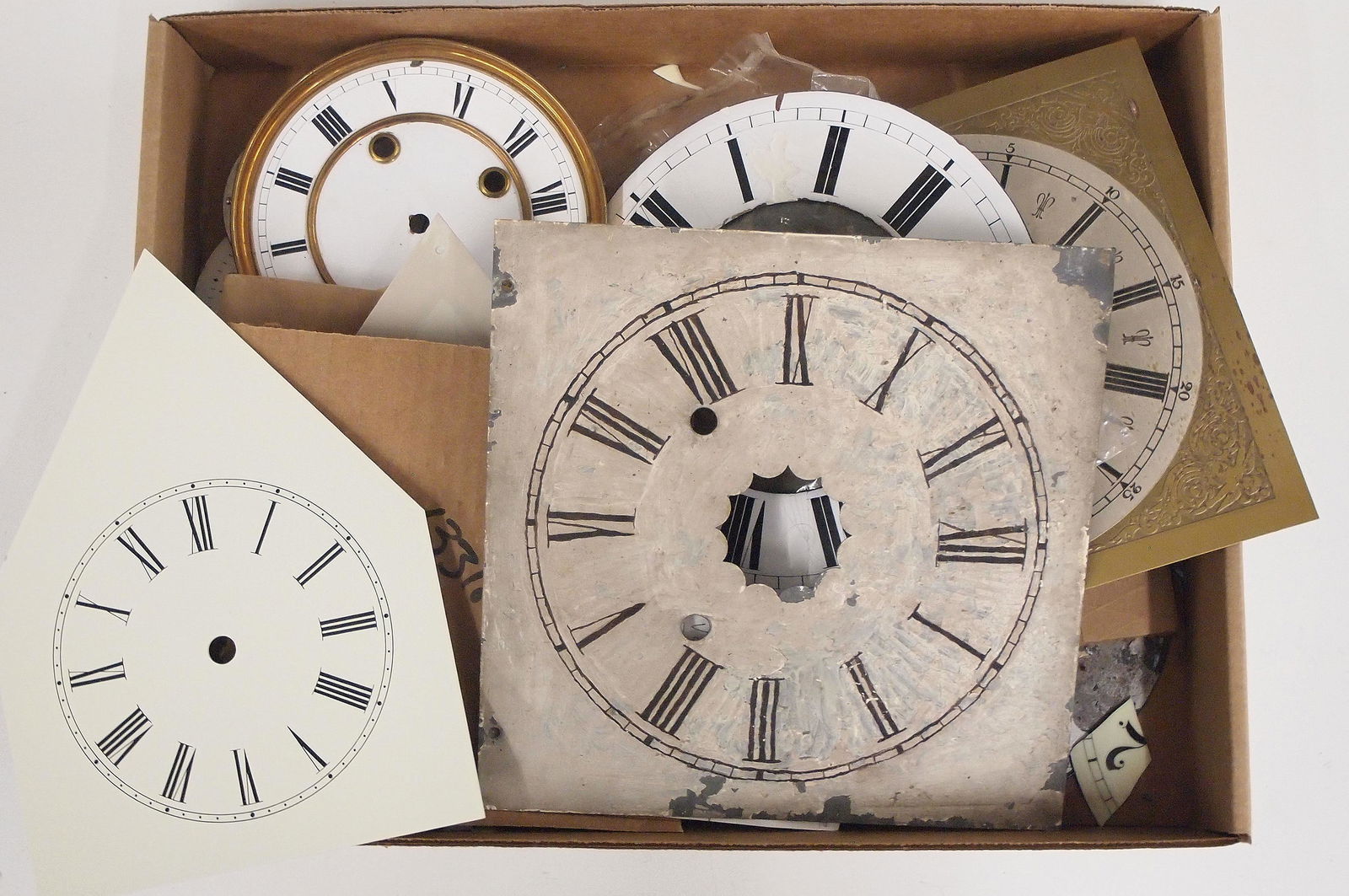 Vintage Clock Dials: A collection of vintage clock dials. Approx. eight clock dials and parts, mostly porcelain. Some with significant damage, As/Found. Up to 7 3/4" diameter. ESTIMATE $20-30