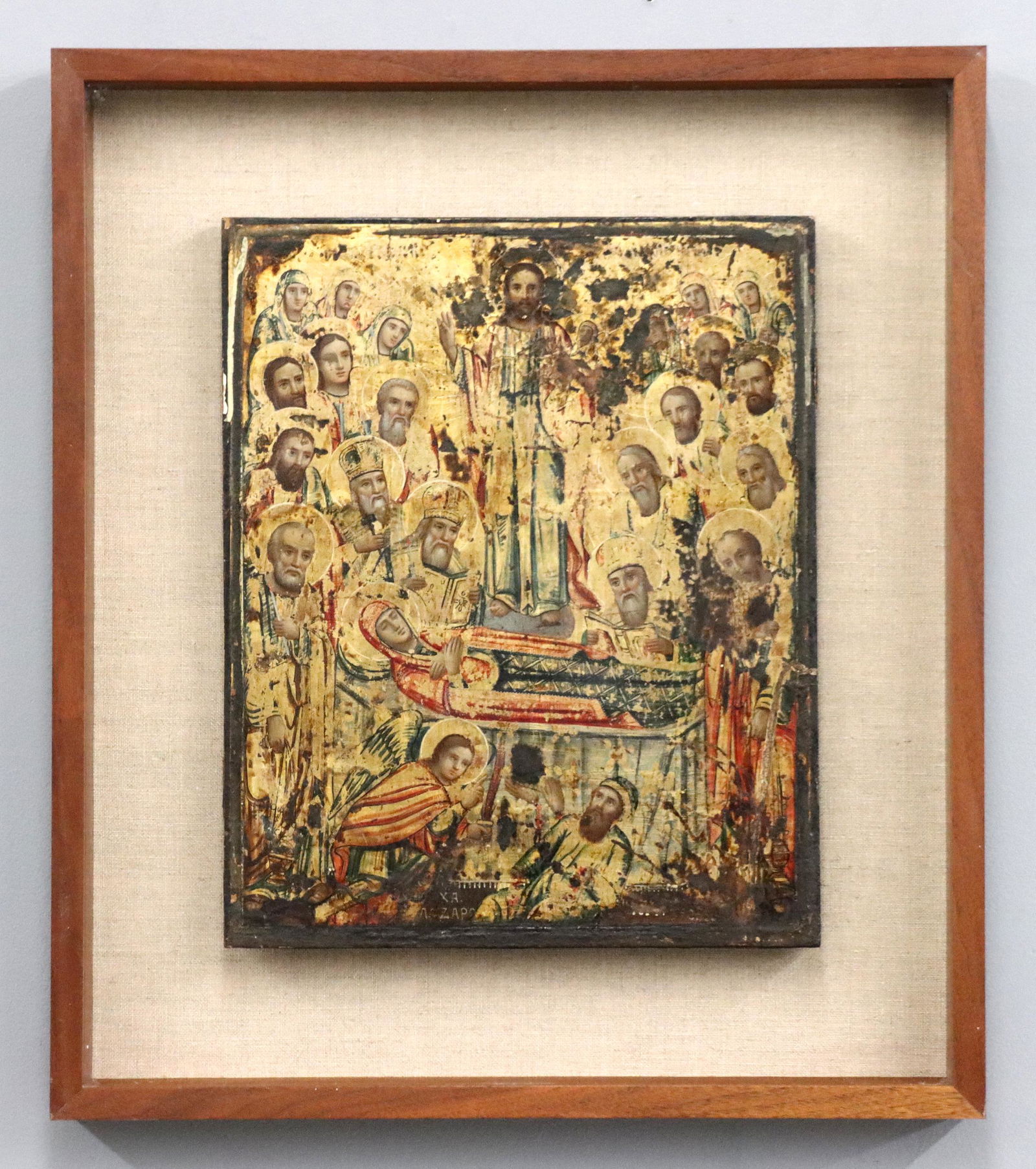 Russian Icon: A turn of the century Russian icon depicting the Dormition of the Virgin. Tempera and gesso on wood panel with Gilded detail. Some wear to panel and paint, repaired corner. Panel is 13 3/4 x 16 3/4" h