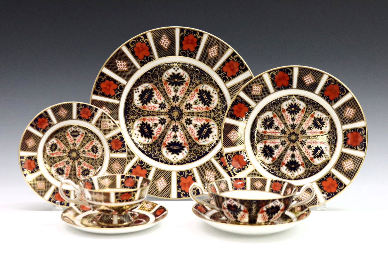 48 Pc Derby Old Imari Dinner Service: A 20th century Royal Crown Derby "Old Imari" pattern fine bone china dinner service set, forty-eight pieces total. Features 8 five-piece place settings. Includes 8 x 10 1/2" dinner plates, 8 x 8 1/2"