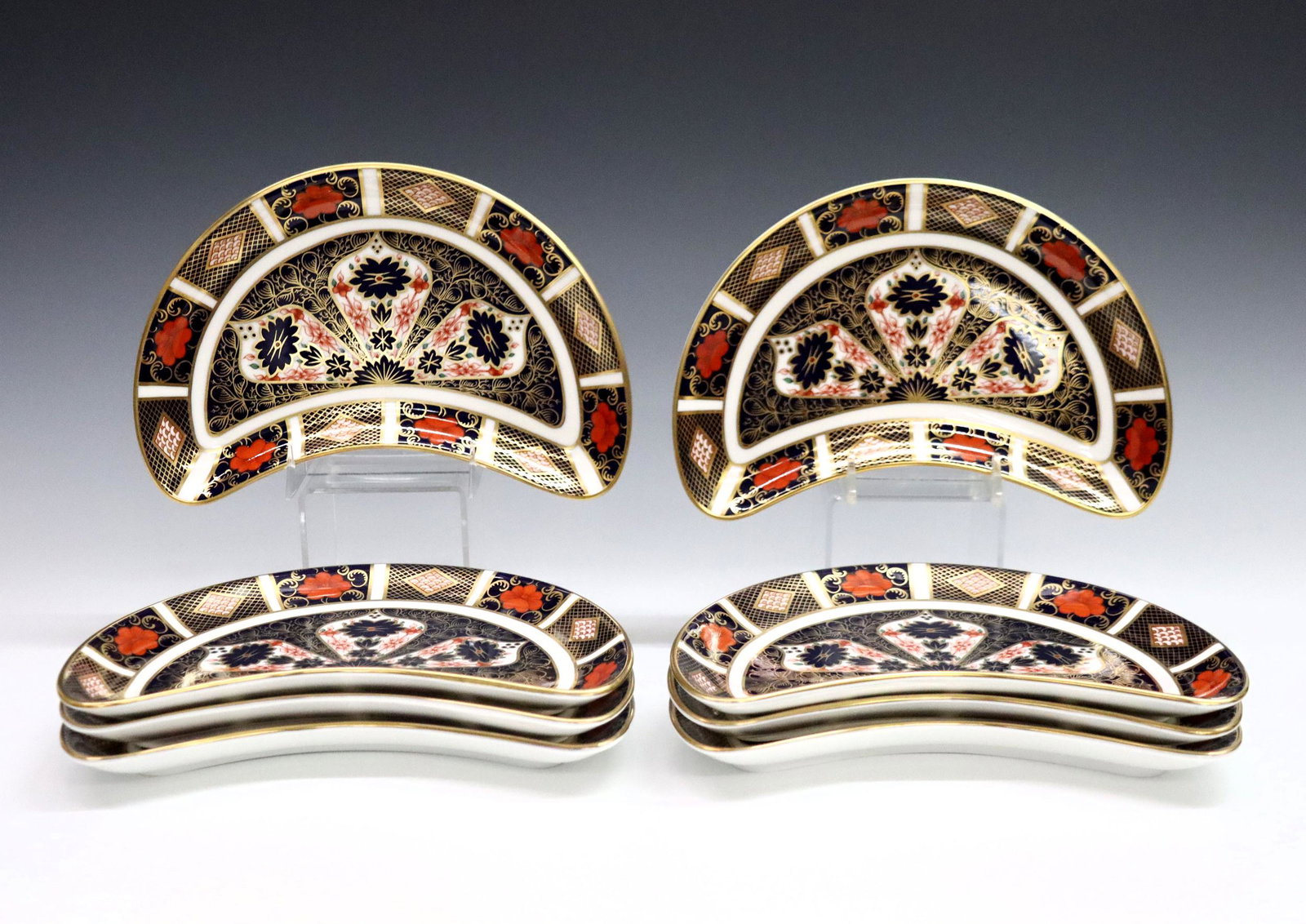 8 Derby Old Imari Crescent Salad Plates: Eight 20th century Royal Crown Derby "Old Imari" pattern fine bone china crescent salad plates. Printed marks in Red with "1128" and "LII". Good condition, very slight surface wear. 8 3/4" long. ESTIM