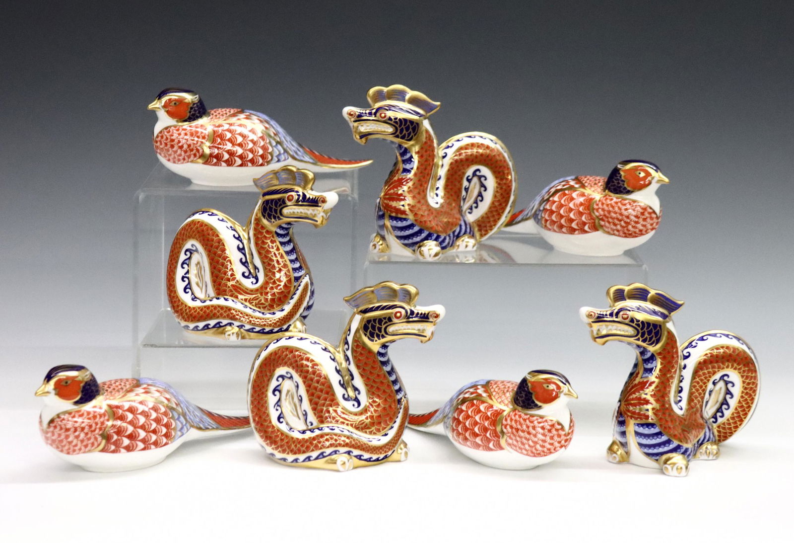 8 Derby Imari Figures: Eight 20th century Royal Crown Derby "Imari" pattern fine bone china figures. Includes four dragons and four pheasants. Printed marks in Red with "LII". Good condition, very slight surface wear, two w