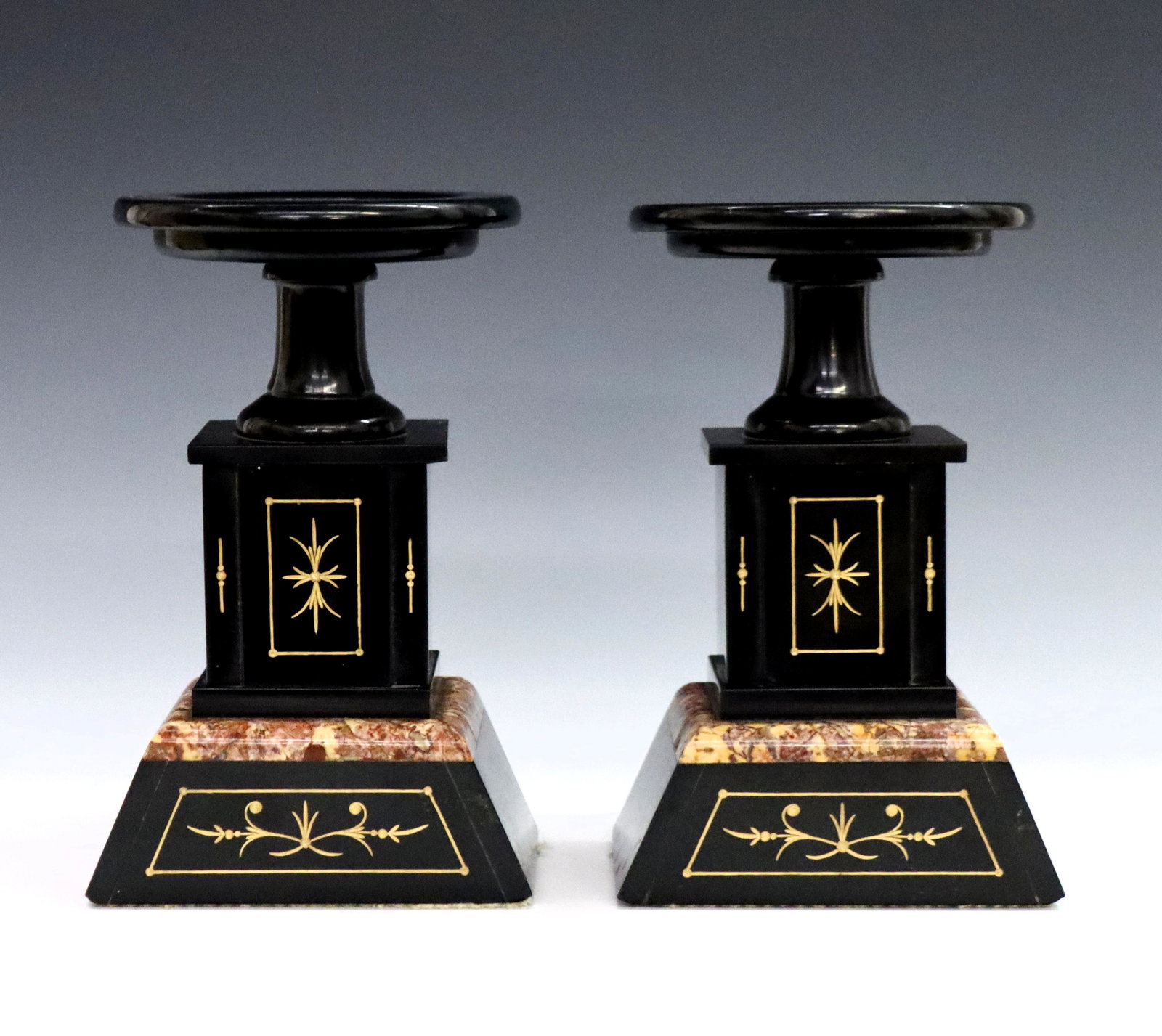 Pr French Garnitures: A pair of 19th century French Marble garnitures. Neoclassical design in Black marble with Gilded incised detail. Slight wear, minor flakes and small chips to Marble. Each 8" high. ESTIMATE $100-150