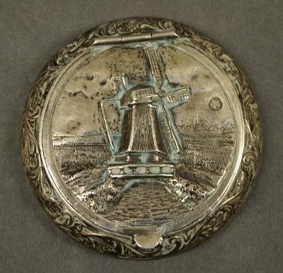 Dutch Silver snuff box: A 20th century Dutch Silver snuff. Repousse landscape decoration with windmill on hinged cover. Hallmarks for 1926, and .833 Silver. Minor wear. 2 1/4" diameter. 1.15 troy ozs. ESTIMATE $100-150