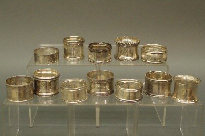 12 Sterling napkin rings: A collection of 12 early 20th century Sterling Silver napkin rings. Various makers and patterns. Minor wear, some monogrammed. 6.10 troy ozs total. ESTIMATE $200-300