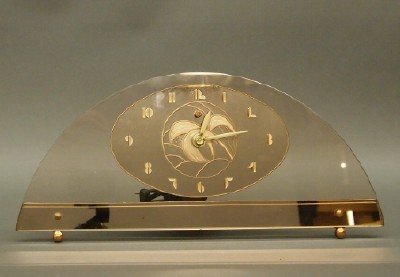 Art Deco clock: An Art Deco electric desk clock. GE model 6H02 clock with a Peach color arched dial. Some wear. 7 3/4" high. ESTIMATE $100-150