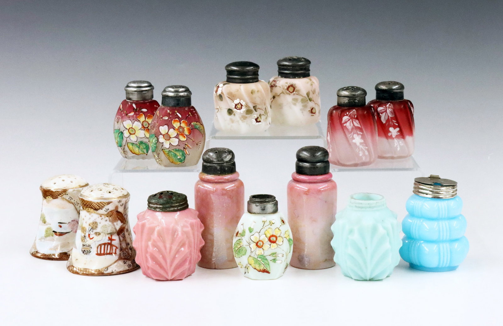 14 Art Glass & Porcelain Shakers: A collection of fourteen 19th century Art Glass and porcelain shakers. Various designs of Satin glass, Agate glass, Opaline and porcelain by makers including Wave Crest, Consolidated and others. Some