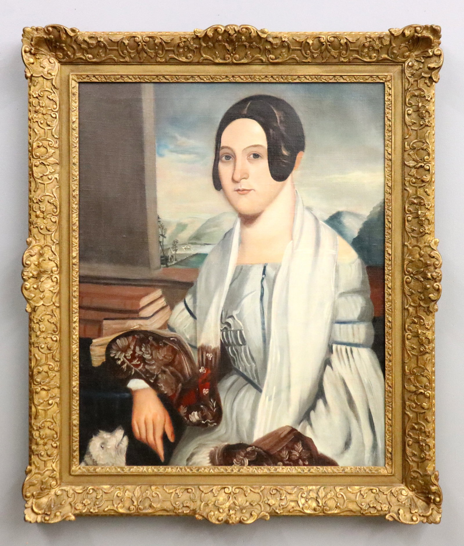 American Portrait of a Young Lady: A 19th century American portrait of a young lady. Depicted seated with a small dog and mountainous landscape in the background beyond an open window. Unsigned, label from "Havard Freres, Paris" galler