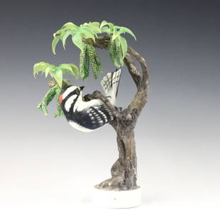 Royal Worcester Woodpecker Figure: A 1960's Royal Worcester "Little Downy Woodpecker and Pecan" porcelain figure designed by Dorothy Dougherty. Printed maker's marks, titled and dated "1967" with printed artist signature at underside.