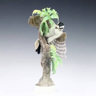 Royal Worcester Woodpecker Figure: A 1960's Royal Worcester "Little Downy Woodpecker and Pecan" porcelain figure designed by Dorothy Dougherty. Printed maker's marks, titled and dated "1967" with printed artist signature at underside.