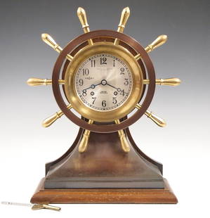 Chelsea Mariner Ship's Clock: A mid 20th century Chelsea Clock Co. "Mariner" model ship's clock. 8 day time and strike movement with Silvered dial, Arabic numerals and Ships Bell striking, marked "Donovan & Seamans Co., Los Angele