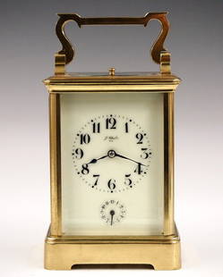 French Carriage Clock: A late 19th century French Carriage clock, retailed by "J. Chrestin, Nice". 8-day movement with Petite Sonnerie strike and Grand Sonnerie repeat, porcelain dial with Arabic numerals and subsidiary ala