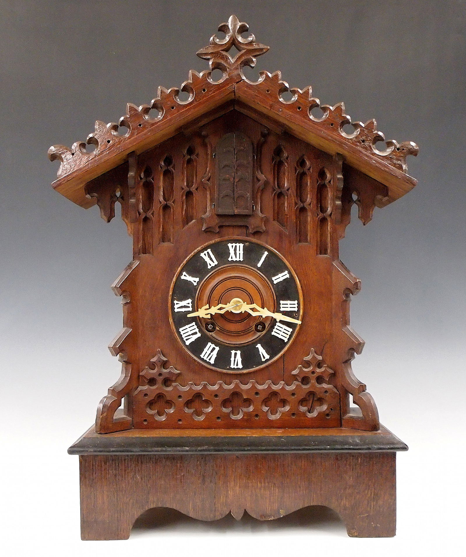 Black Forest Trumpeter Table Cuckoo Clock: A 19th century Black Forest table top Trumpeter Cuckoo clock. 8-day time and strike movement with Brass cutout plates, shield form pendulum and three horns, turned wooden dial and applied bone hands a