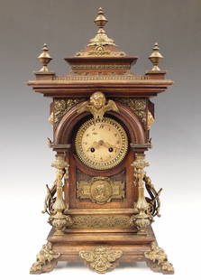 German Bracket Clock: A late 19th century German Bracket clock. 8-day spring driven time and strike movement with Silvered dial and Arabic numerals, cast Brass bezel and filigree hands. Oak case with cast Brass finials and