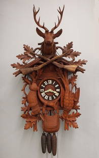 Black Forest Musical Cuckoo Wall Clock: A late 20th century German Black Forest musical Cuckoo wall clock. 30-hr three weight movement with Brass cutout plates, cuckoo and musical chime at the hour and half, turned wooden dial with applied