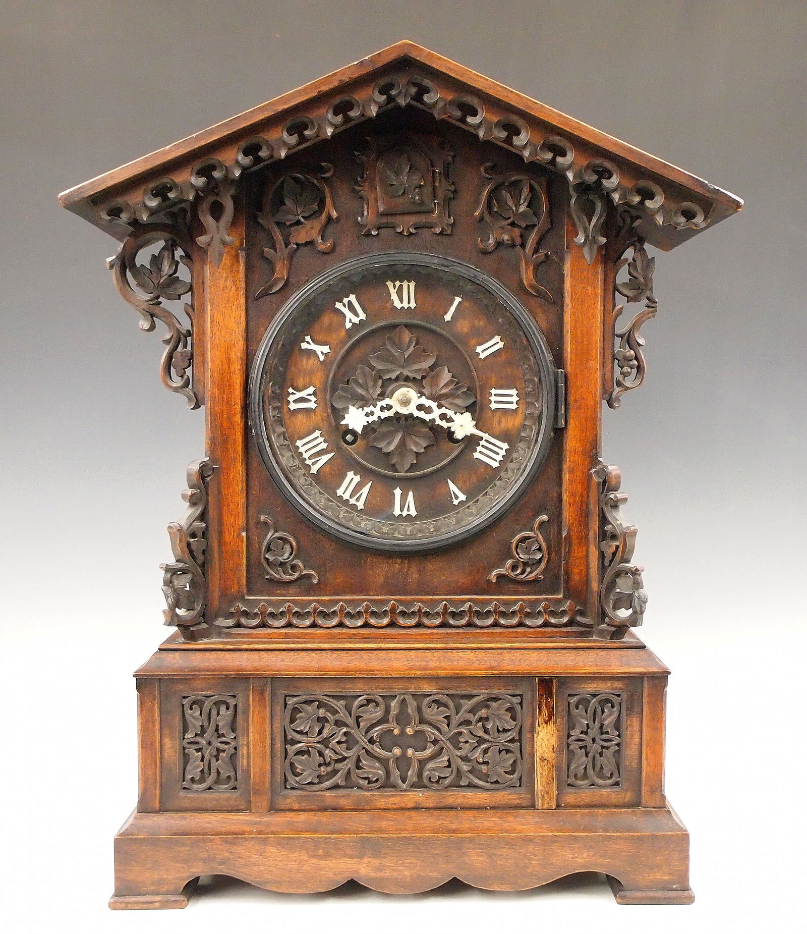 Black Forest Table Cuckoo Clock: A 19th century Black Forest table top Cuckoo clock. 8-day double fusee time and strike movement with wooden plates, carved dial and applied bone hands and Roman numerals. Walnut Gothic Revival Period