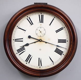 Ansonia Gallery Clock: A late 19th century Ansonia Gallery clock. 8-day time and strike movement with 18" painted metal dial and Roman numerals, subsidiary seconds. Molded Mahogany case with lift door. Some finish wear, min