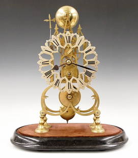 English Skeleton Clock: A 20th century Brass Skeleton clock. 8-day Fusee driven movement with passing strike and Silvered cut out dial with Roman numerals. Shaped Brass plates with turned posts on a molded wooden base. Minor