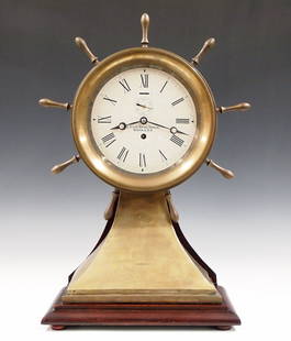 Brass Ship's Wheel Clock: A late 20th century "U. S. Life-Saving Service, Boston, U.S.A." mantel clock. Modern 8 day time only movement with platform escapement, papered metal dial, Roman numerals and subsidiary seconds. Brass